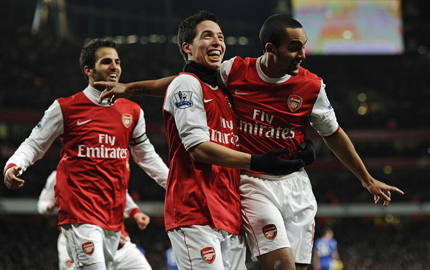  Arsenal's Theo Walcott (R) celebrates his goal against Chelsea with Samir Nasri (C) and Cesc Fabregas during their English Premier League soccer match at the Emirates Stadium in London yesterday.