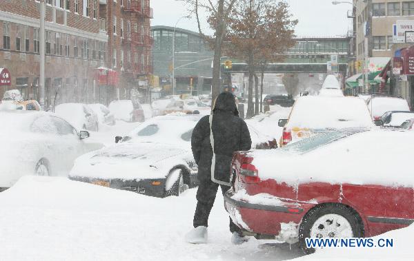 A man walks on the snow-covered street after a blizzard in the New York City borough of Queens on Dec. 27, 2010. A snow storm that swept through Northeast United States on Monday wrecked havoc for commuters and travelers, as the blizzard left airports closed, rail and highway travel in disarray. 