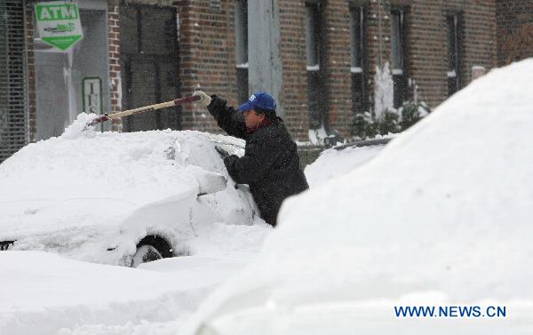 A man removes snow from his car after a blizzard in the New York City borough of Queens on Dec. 27, 2010. 