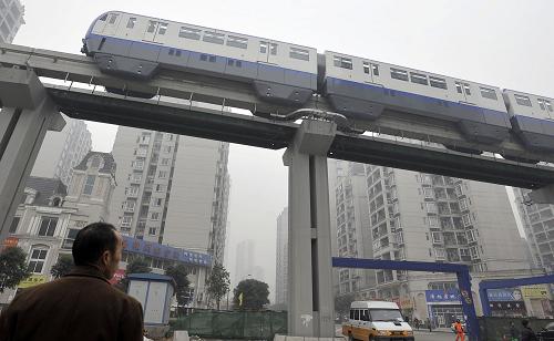 A trial train of Chongqing Subway Line No.3 runs on elevated rail in southwest China&apos;s Chongqing Municipality, Dec. 28, 2010. The subway line, with the highest speed of 75km per hour, started its trial run on Tuesday. It will be formally put into operation in June of next year. [Xinhua]