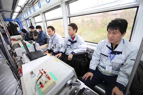 Workers test on a trial train of Chongqing Subway Line No.3 in southwest China&apos;s Chongqing Municipality, Dec. 28, 2010. The subway line, with the highest speed of 75 km per hour, started its trial run on Tuesday. It will be formally put into operation in June of next year. [Xinhua]