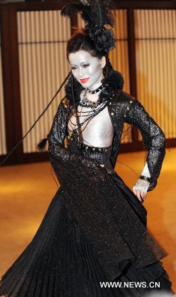 A model presents designed costume for an avant-garde musical 'The Lady of the Camellias' in Taipei, southeast China's Taiwan, Dec. 28, 2010. An innovated musical adapted from the classic novel 'The Lady of the Camellias' will be staged in Taipei in 2011 February.