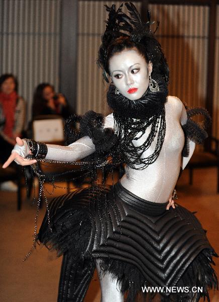 A model presents designed costume for an avant-garde musical 'The Lady of the Camellias' in Taipei, southeast China's Taiwan, Dec. 28, 2010. An innovated musical adapted from the classic novel 'The Lady of the Camellias' will be staged in Taipei in 2011 February.