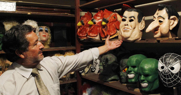 Vicente Paredes, a former hairstylist who became a mask maker since 40 years ago, shows the masks of Ecuadorean President Rafael Correa and former President Lucio Gutierrez in Quito Dec 29, 2010.