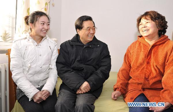 Chinese President Hu Jintao (C), also general secretary of the Communist Party of China (CPC) Central Committee and chairman of the Central Military Commission (CMC), talks to people living in a residential community for low-income groups in Beijing, capital of China, Dec. 29, 2010.