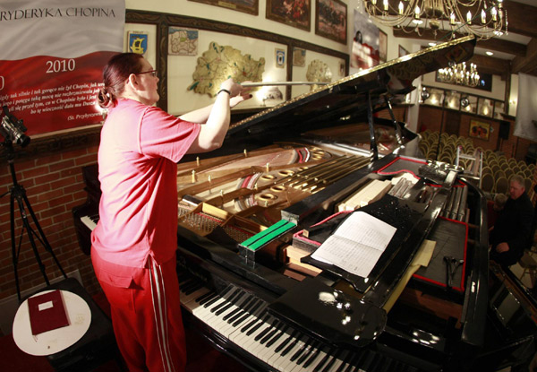 A staff member prepares the Stolemowi Klawer, which is in contention for the title of the world&apos;s biggest concert piano, ahead of an event to mark the end of Chopin Year at a museum in Shymbark, northern Poland Dec 30, 2010. [China Daily/Agencies]