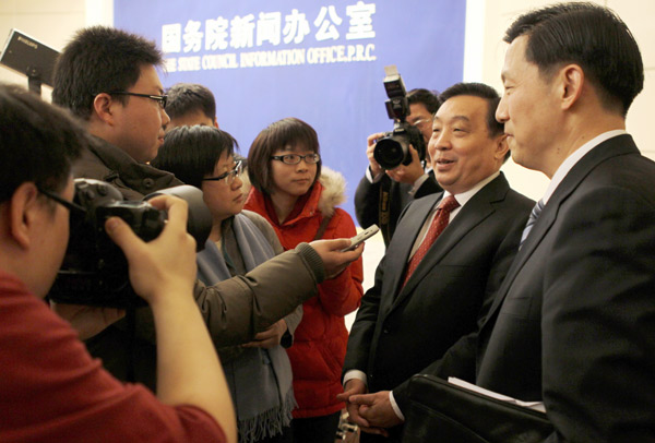 Wang Chen (second from right), minister of the State Council Information Office, is interviewed after a news conference on Thursday in Beijing. [Yang Shizhong / China Daily]