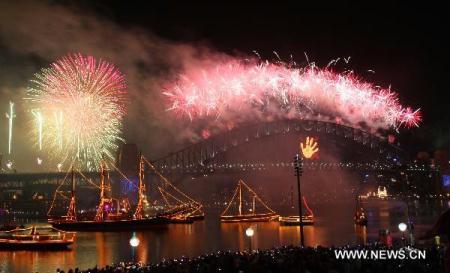 Fireworks explode over the Sydney Harbour Bridge during a pyrotechnic show to celebrate the New Year in Sydney, Australia, Jan. 1, 2011. [Xinhua/Jiang Yaping]
