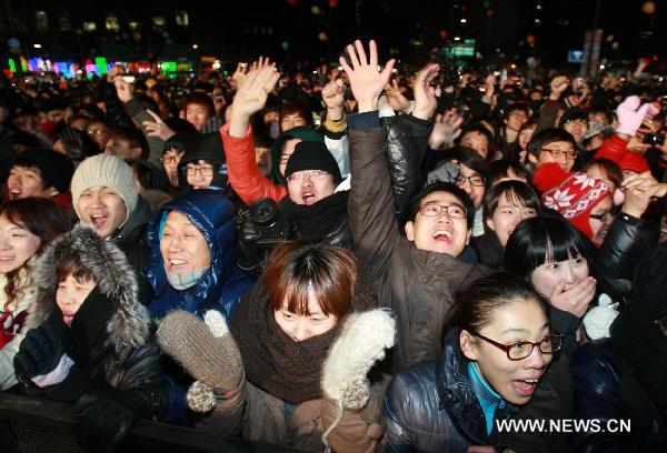 People celebrate the coming of the new year in downtown Seoul, capital of South Korea, on Dec. 31, 2010. Tens of thousands of people took part in the celebration despite the cold weather.