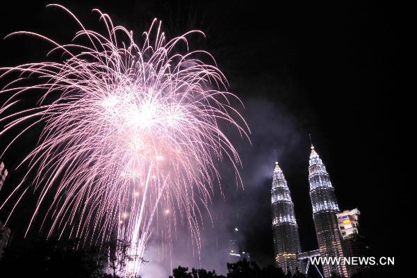 Fireworks explode in front of the Petronas Twin Towers during New Year celebrations in Kuala Lumpur, Malaysia, on Jan. 1, 2011.