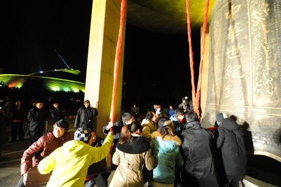 People sound the bell in the China Millennium Monument in Beijing on December 31 to celebrate the coming of the year 2011. [Xinhua photo]