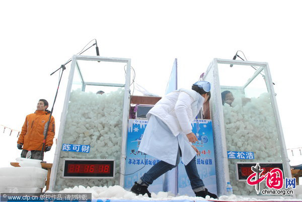 Chinese &apos;Icemen&apos; Chen Kecai (L, Front) and Jin Songhao (R, Font) stand immersed in ice during a cold endurance competition in Zhangjiajie, central China&apos;s Hunan Province, Jan. 3, 2010. [Xinhua]