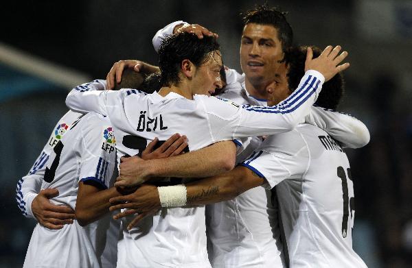 Real Madrid's Mesut Ozil (front, 2nd L) celebrates his goal against Getafe with his teammates during their Spanish first division soccer league match at Colisseum Alfonso Perez stadium in Madrid January 3, 2011. (Xinhua/Reuters Photo) 