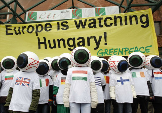 Greenpeace activists with eyeball-shaped helmets line up outside the Hungarian Foreign Ministry in Budapest January 3, 2011. The activists said Hungary, which took the rotating presidency of the European Union on January 1, should tackle issues such as CO2 emissions, genetically modified crops, pollution and renewable energy. [Xinhua/Reuters] 