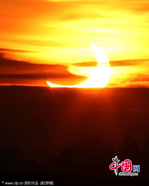 The sun appears in the sky over The Fens in Peterborough, Cambridgeshire, UK, in the midst of a partial eclipse, Jan. 4, 2011. [CFP]