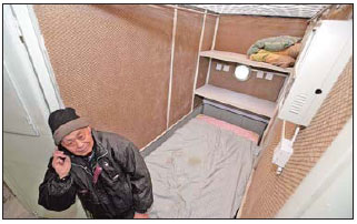 Designer Huang Rixin in a capsule apartment. Provided to China Daily