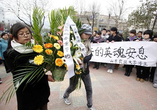 People mourn for police officers who died chasing the two gunmen on Jan. 4, 2011 in Shandong province. [Xinhua]