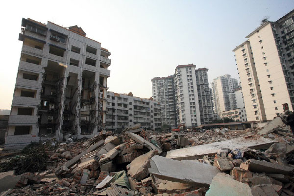 A photo of a half-demolished building dubbed 'the castle in the air' has raised a storm among Chinese netizens. The seven-floor building was demolished from the bottom up leaving only the top two floors clinging precariously to a crumbling structure.