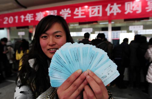 A woman from Zhejiang University of Technology shows tickets she bought for students, at Hangzhou Railway Station in Hangzhou, East China&apos;s Zhejiang province, Jan 5, 2011. [Xinhua]