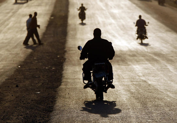 Southern Sudanese men ride motorcycles during sunset in Juba, Jan 5, 2011. [China Daily/Agencies]