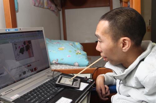 Zhang Yunpeng, 34, uses a chopstick to upload pictures of his brush paintings online. The success of the Zhang brothers' store on Taobao has made them role models for the millions of disabled people across China. 