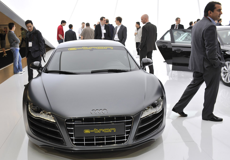 People walk by the Audi e-tron Spyder concept car during the 2011 International Consumer Electronics Show in Las Vegas, the United States, Jan 7, 2011. The 2011 International Consumer Electronics Show (CES) runs from Jan 6 to Jan 9. [Xinhua]