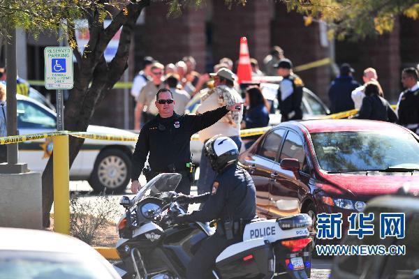 Law enforcement personnel work a crime scene where US Representative Gabrielle Giffords (D-AZ) was shot along with others at a Safeway in Tucson, Arizona Jan 8, 2011. Giffords was shot in the head while holding a public event in Tucson, Arizona on January 8, 2011. 