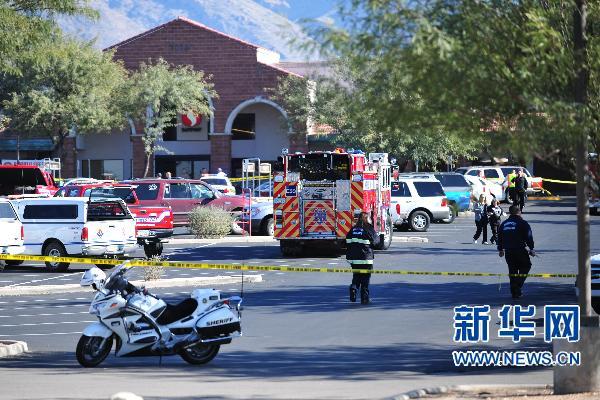 Law enforcement personnel work a crime scene where US Representative Gabrielle Giffords (D-AZ) was shot along with others at a Safeway in Tucson, Arizona Jan 8, 2011. 