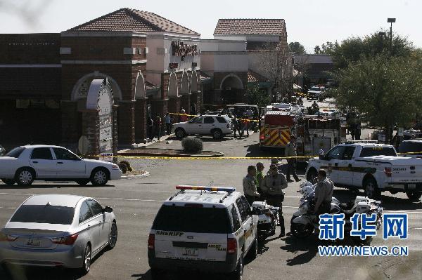 Law enforcement personnel work a crime scene where US Representative Gabrielle Giffords (D-AZ) was shot along with others at a Safeway in Tucson, Arizona Jan 8, 2011.