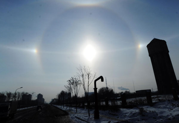 A parhelion (also known as sundog) combined with a halo is seen in Changchun, capital of Northeast China&apos;s Jilin province, Jan 8, 2011. The atmospheric phenomenon is created by ice crystals in the air at low levels during a cold weather period.