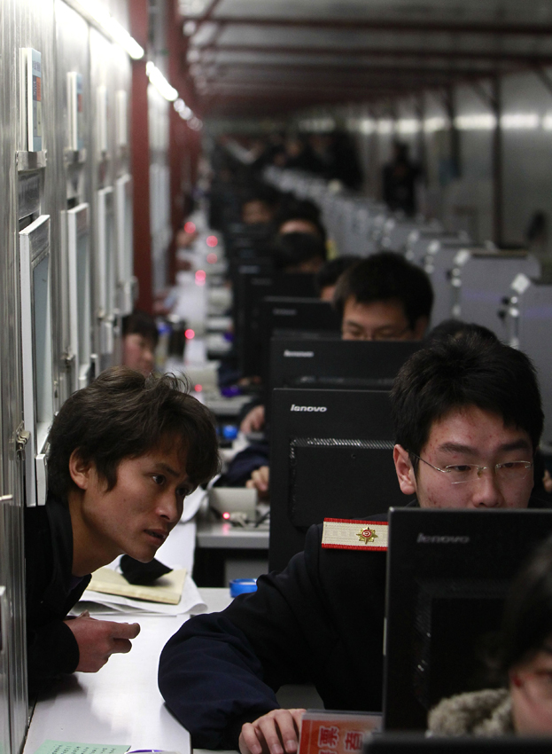 A man buys train tickets at Shanghai Railway Station in Shanghai, east China, Jan. 9, 2011. Shanghai Railway Station started to sell tickets for the 2011 Spring Festival travel on Sunday. The Spring Festival travel will start on Jan. 19. [Xinhua]