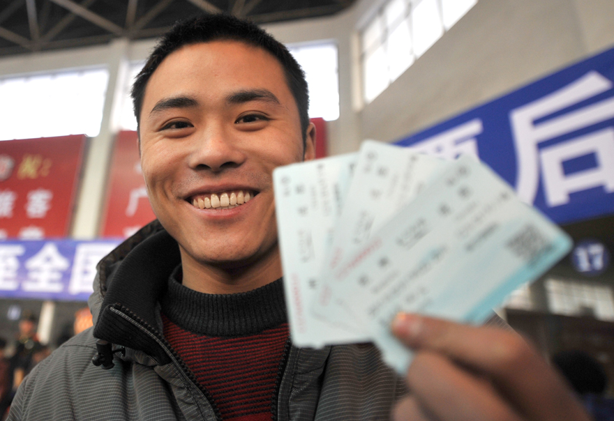 A migrate worker named Liu Qiang shows his train tickets at in Fuyang City, east China&apos;s Zhejiang Province on Jan. 9, 2011. [Xinhua] 