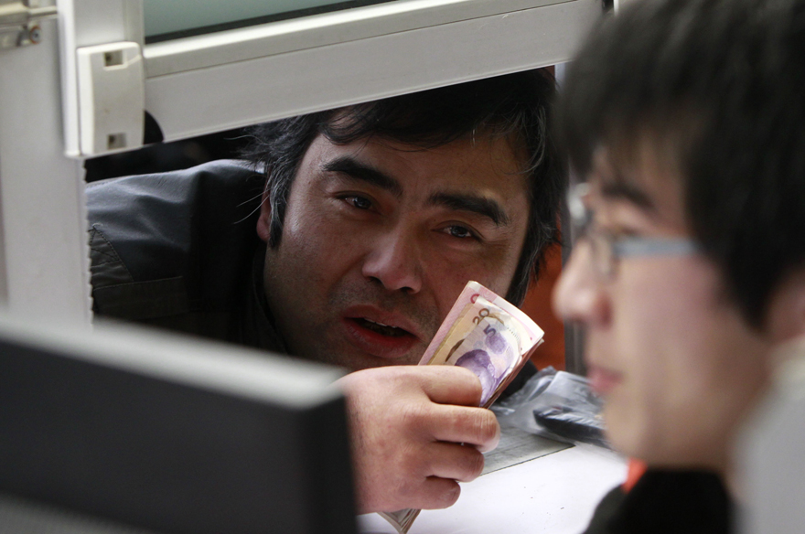 A man buys train tickets at Shanghai Railway Station in Shanghai, east China, Jan. 9, 2011. Shanghai Railway Station started to sell tickets for the 2011 Spring Festival travel on Sunday. The Spring Festival travel will start on Jan. 19. [Xinhua] 