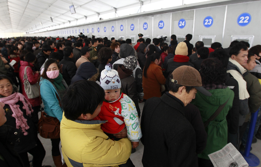 Passengers queue up to buy train tickets at Shanghai Railway Station in Shanghai, east China, Jan. 9, 2011. Shanghai Railway Station started to sell tickets for the 2011 Spring Festival travel on Sunday. The Spring Festival travel will start on Jan. 19. [Xinhua]