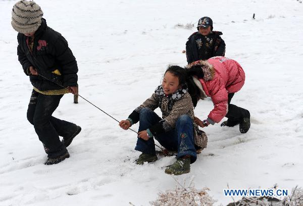Children play at a road covered with snow and ice in a village in Quanzhou County of south China&apos;s Guangxi Zhuang Autonomous Region, Jan. 8, 2010. Despite the difficulty that cold weather brought to local people&apos;s life, children enjoy the fun with the snow-covered world.[Xinhua] 