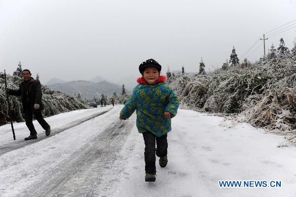A child plays on a road snow and ice in a village in Quanzhou County of south China&apos;s Guangxi Zhuang Autonomous Region, Jan. 8, 2010. Despite the difficulty that cold weather brought to local people&apos;s life, children enjoy the fun with the snow-covered world. [Xinhua] 