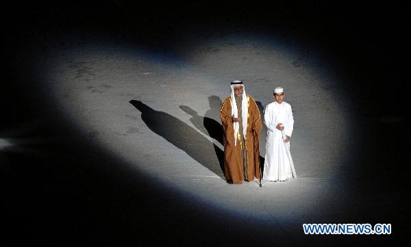 A local elder and a young boy of Qatar chant Arabic poems during the opening ceremony of the 2011 Asian Cup football tournament at Khalifa Stadium in Doha, capital of Qatar, Jan. 7, 2011. (Xinhua/Chen Shaojin)