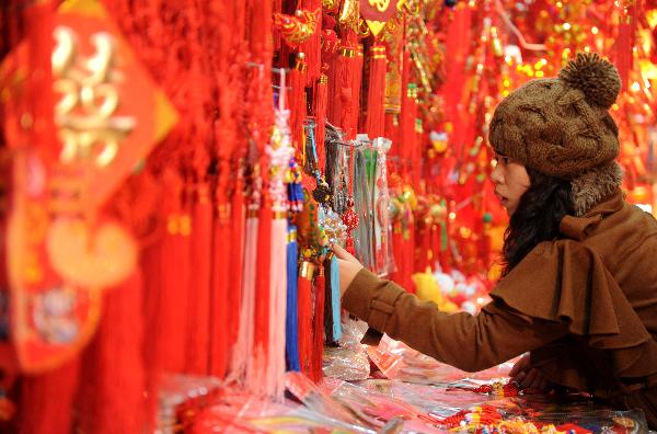 A citizen chooses decorations for the upcoming Spring Festival at a store in Nanchang, capital of central China's Jiangxi Province, Jan. 9, 2011. The year 2011 is the 'Year of the Rabbit' under the 12-year Chinese lunar calendar in which each year is named after one of the twelve Chinese zodiac animals in turn. Therefore, besides traditional decorations for the Spring Festival, products related to rabbit won popularity among buyers this year. 