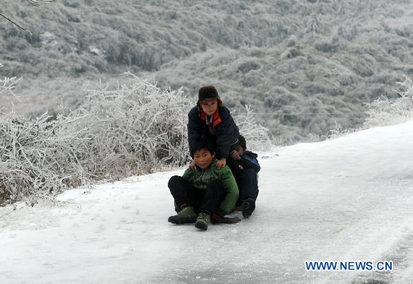 Children play at a road covered with snow and ice in a village in Quanzhou County of south China&apos;s Guangxi Zhuang Autonomous Region, Jan. 8, 2010. Despite the difficulty that cold weather brought to local people&apos;s life, children enjoy the fun with the snow-covered world. [Xinhua]