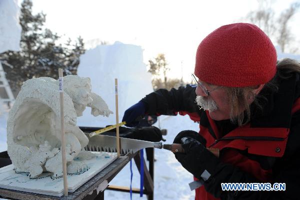 A contestant participates in a snow sculpture contest in Harbin, capital of northeast China&apos;s Heilongjiang Province, Jan. 10, 2011. The 27th China Harbin International Ice and Snow Festival opened here on Monday. [Xinhua]