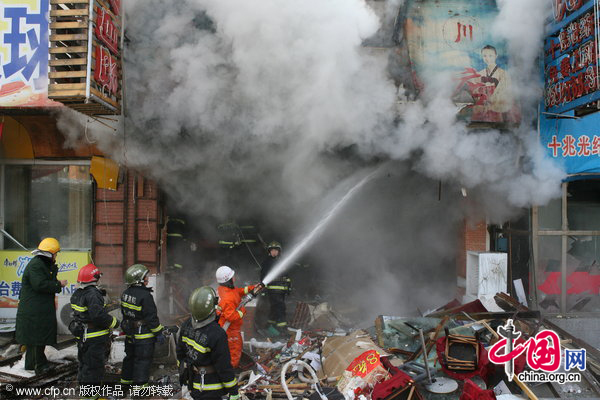 Firefighters work at the explosion site on January 10, 2011 in Changchun, Jilin Province of China. The explosion occurred at 10:00 am at a restaurant, injured 14 customers and the reason is under investigation. [CFP]