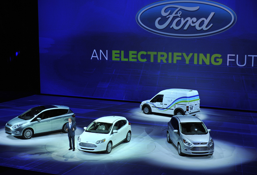 Bill Ford Jr., executive chairman of Ford Motor Company stands beside a Ford Focus electric car during the press day for the North American International Auto show in Detroit, Michigan Jan 10, 2011. [Photo/Xinhua]