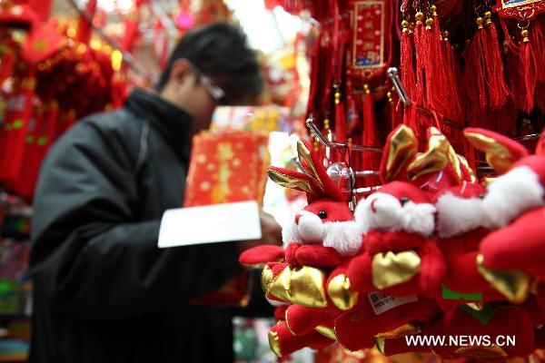 A customer selects New Year decorations in a market in Macao, south China, Jan. 11, 2011 for the upcoming Spring Festival of the Year of Rabbit in Chinese Lunar Calendar. [Xinhua] 