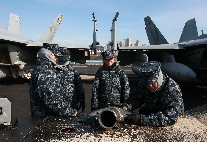Crew members work on the deck of the U.S. aircraft carrier USS Carl Vinson which is anchored at a South Korean navy port in Busan, South Korea, on Jan. 11, 2011. [Xinhua] 