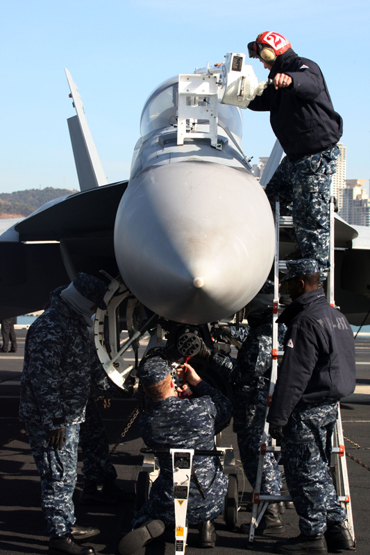 Crew members work on the deck of the U.S. aircraft carrier USS Carl Vinson which is anchored at a South Korean navy port in Busan, South Korea, on Jan. 11, 2011. [Xinhua] 