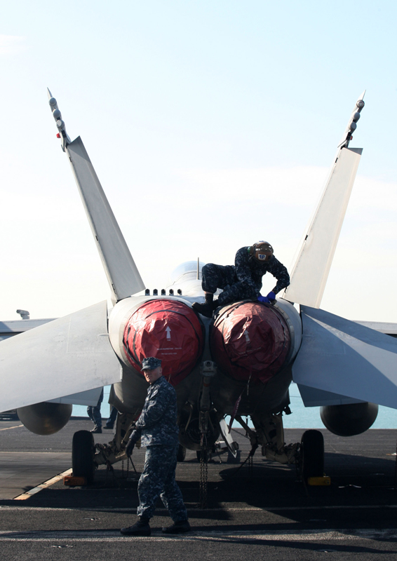 Crew members work on the deck of the U.S. aircraft carrier USS Carl Vinson which is anchored at a South Korean navy port in Busan, South Korea, on Jan. 11, 2011. [Xinhua] 