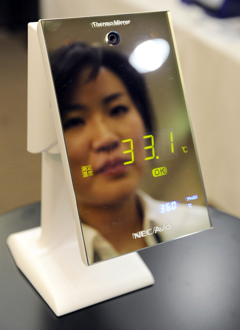 The world&apos;s first mirror thermometer, NEC Avio Infrared Technologies&apos; &apos;Thermo Mirror&apos;, is unveiled in Tokyo. The device measures the user&apos;s skin temperature without the need for physical contact, using a built-in infrared sensor. [Xinhua]