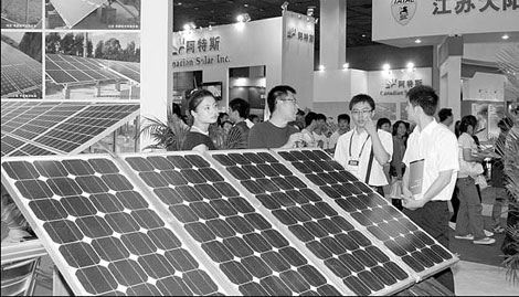 Visitors talk with exhibitors at the 2nd China (Wuxi) Renewable Energy Conference Solar Power Exhibition in September. Wuxi plans to adopt green technology to meet energy targets. [China Daily] 