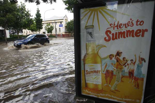 A car moves through a flooded street in the Brisbane suburb of West End January 12, 2011. 