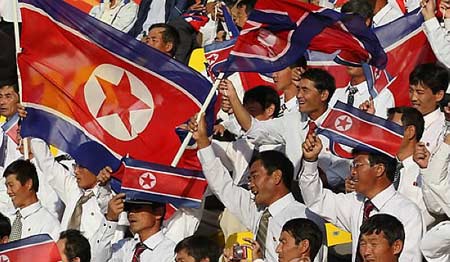 DPRK&apos;s cheering squad wave national flags during their 2011 Asian Cup Group D soccer match against United Arab Emirates at Qatar Sports Club stadium in Doha, Jan 11, 2011. [msn.com.cn] 
